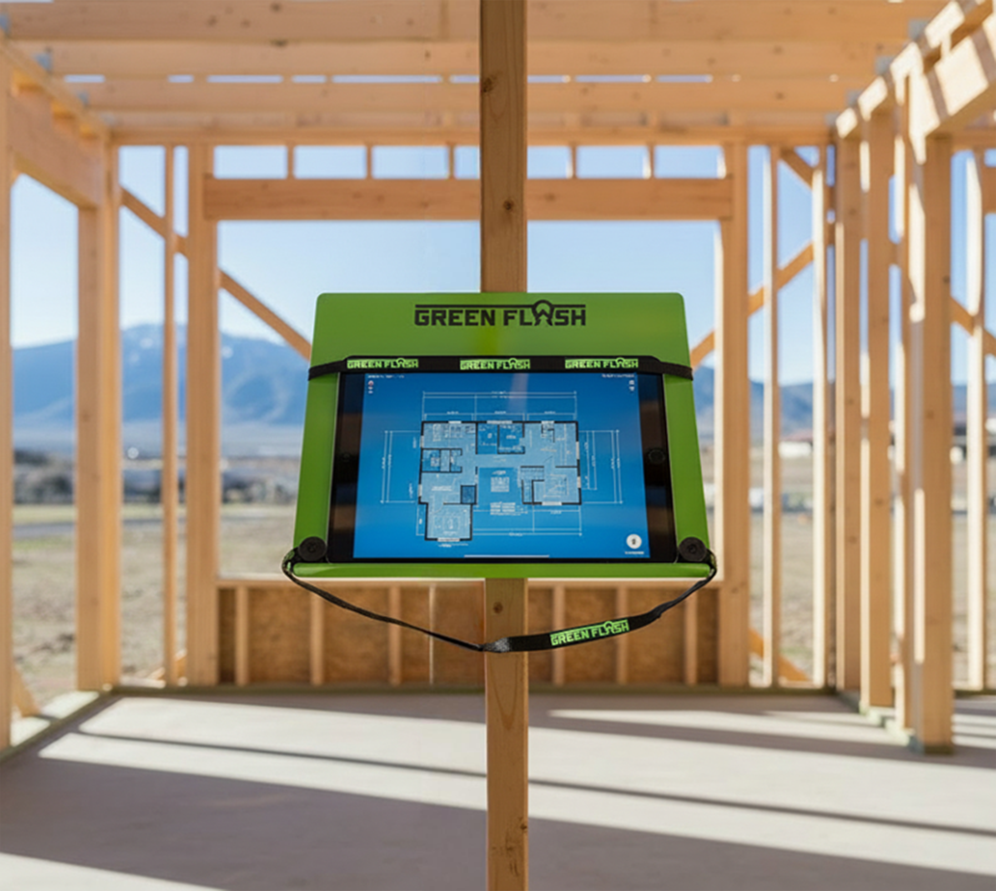 GREEN FLASH mobile jobsite desk mounted to a wood stud holding a digital tablet with construction blue print plans
